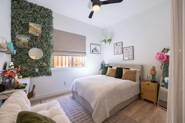 a view of a book shelf with lots of frames on wall