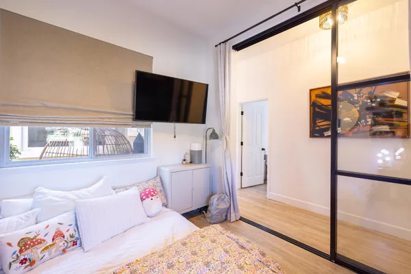 a view of a hallway with wooden floor and furniture