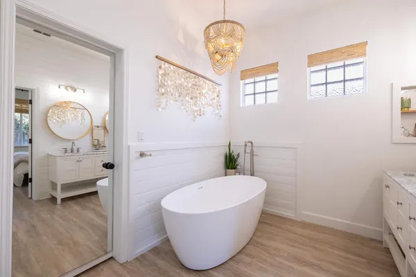 a view of a backyard with wooden fence and a couple of plants