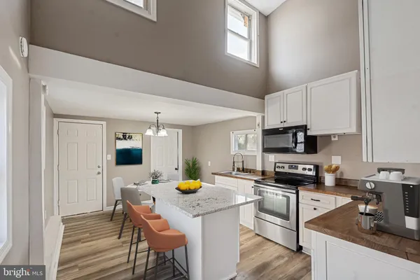 a kitchen with a stove a sink and a refrigerator