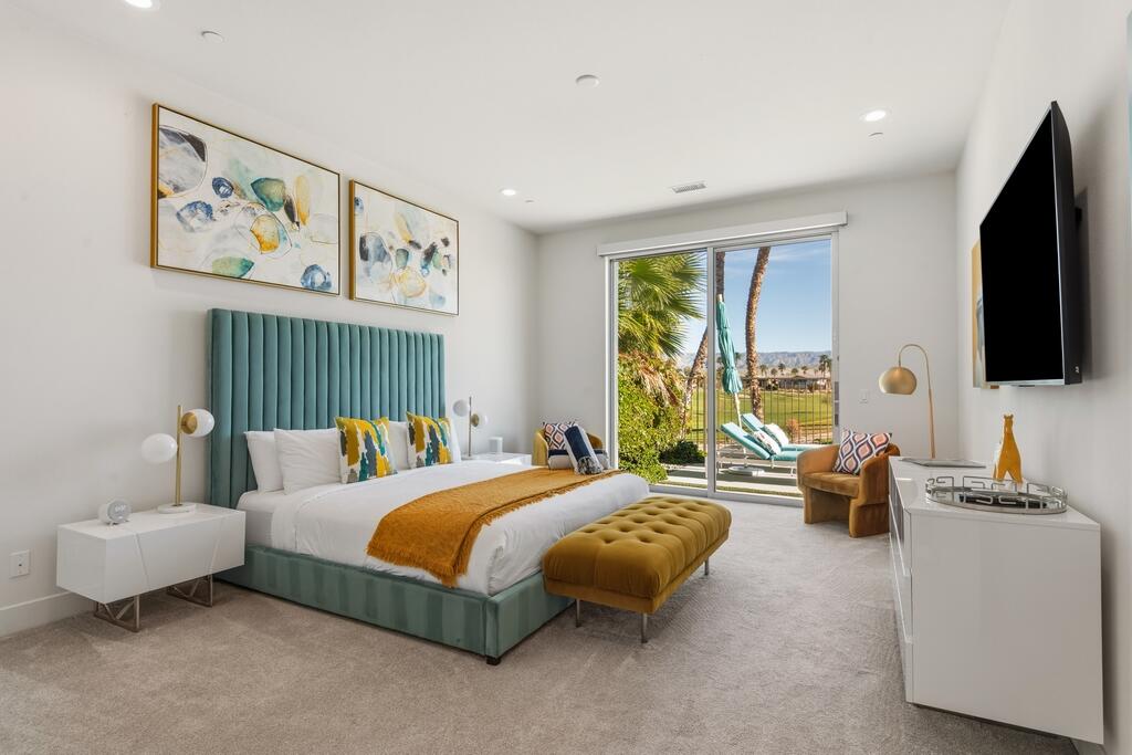 1200 Celadon Street Palm Springs, CA 92262 - Photo 13 of 47 a bedroom with a bed couch and a flat screen tv