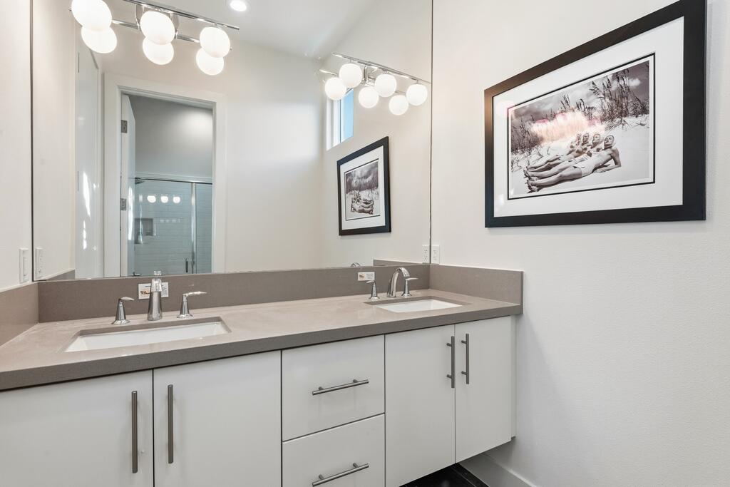 1200 Celadon Street Palm Springs, CA 92262 - Photo 19 of 47 a bathroom with a double vanity sink and a mirror