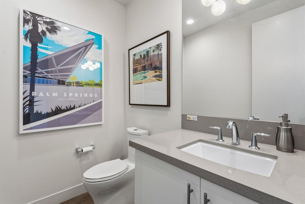 1200 Celadon Street Palm Springs, CA 92262 - Photo 22 of 47 a bathroom with a toilet sink and mirror