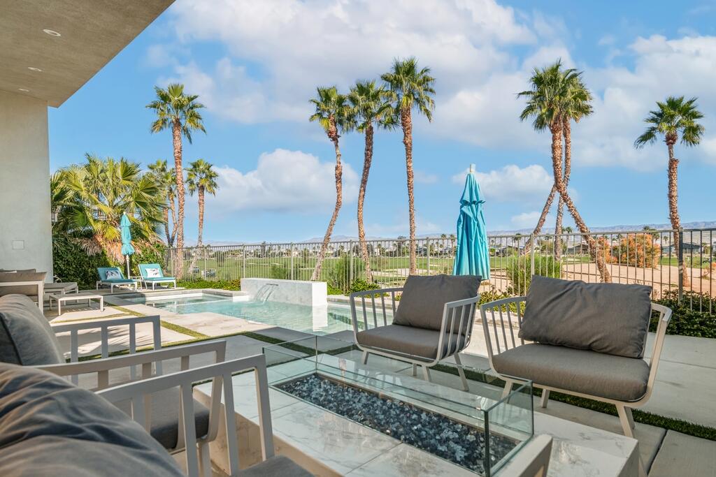 1200 Celadon Street Palm Springs, CA 92262 - Photo 31 of 47 a view of a swimming pool with a couches and wooden floor