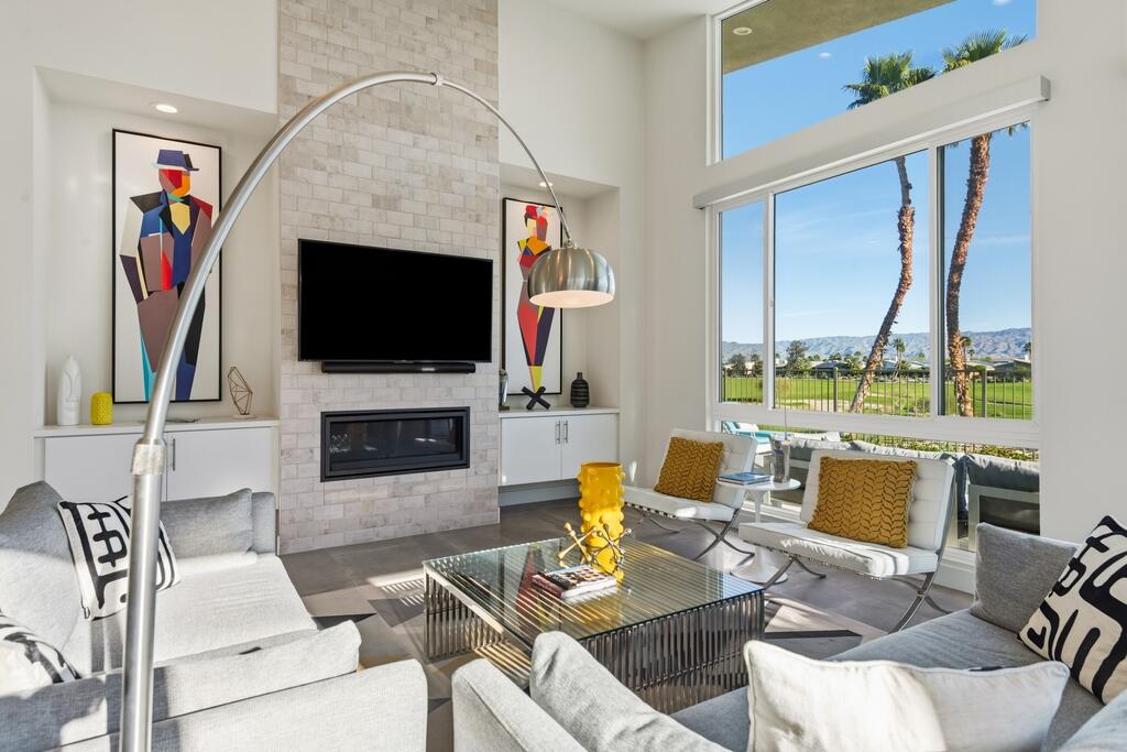 1200 Celadon Street Palm Springs, CA 92262 - Photo 4 of 47 a living room with furniture a fireplace and a flat screen tv