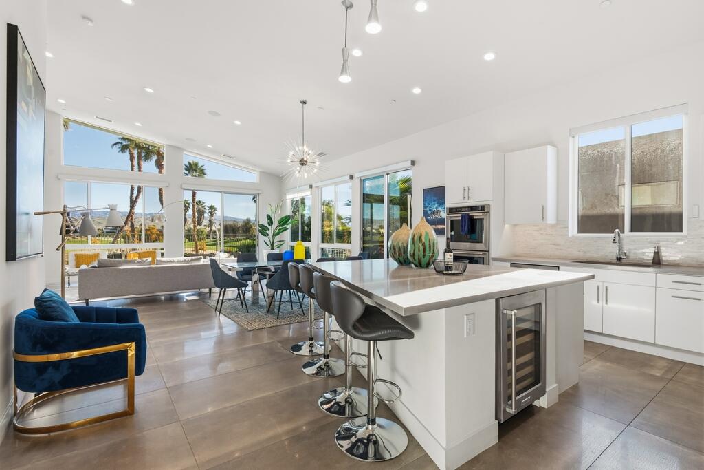 1200 Celadon Street Palm Springs, CA 92262 - Photo 8 of 47 a kitchen with lots of counter top space and painting on the wall