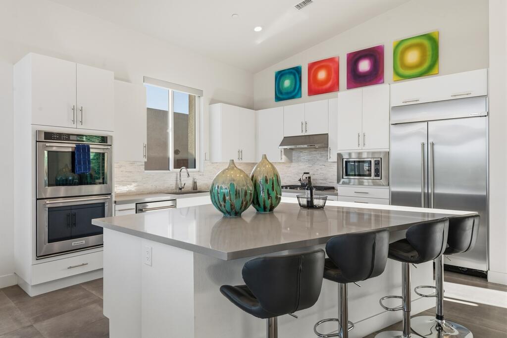 1200 Celadon Street Palm Springs, CA 92262 - Photo 9 of 47 a kitchen with stainless steel appliances a sink and a refrigerator