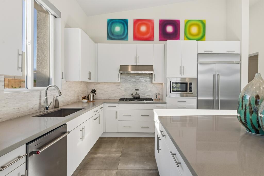 1200 Celadon Street Palm Springs, CA 92262 - Photo 10 of 47 a kitchen with granite countertop a sink stainless steel appliances and cabinets