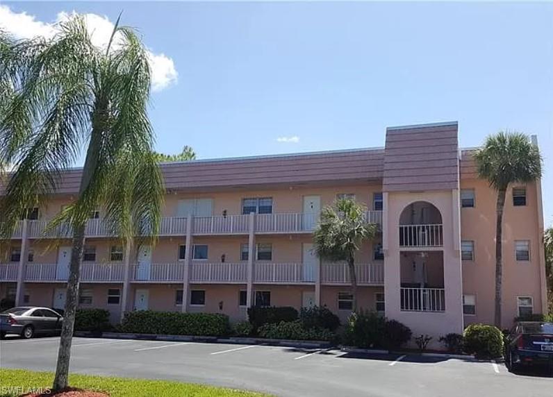175 Turtle Lake Court, Unit 111 Naples, FL 34105 - Photo 1 of 19 a front view of a house with yard