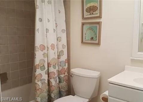 175 Turtle Lake Court, Unit 111 Naples, FL 34105 - Photo 12 of 19 a white toilet sitting next to a bathroom sink