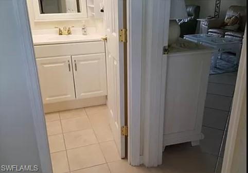 175 Turtle Lake Court, Unit 111 Naples, FL 34105 - Photo 13 of 19 a bathroom with a sink and a mirror