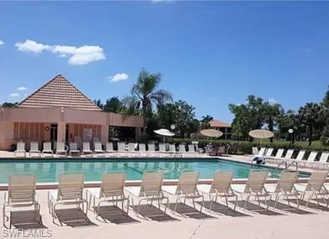 175 Turtle Lake Court, Unit 111 Naples, FL 34105 - Photo 15 of 19 a view of a lake with a house