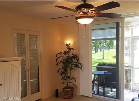 175 Turtle Lake Court, Unit 111 Naples, FL 34105 - Photo 6 of 19 a glass vase sitting on a table with a potted plant