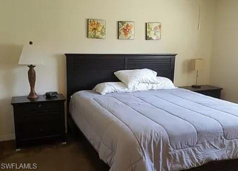 175 Turtle Lake Court, Unit 111 Naples, FL 34105 - Photo 7 of 19 a bedroom with a bed and a dresser