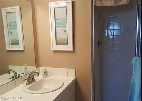 175 Turtle Lake Court, Unit 111 Naples, FL 34105 - Photo 8 of 19 a bathroom with a sink and a mirror