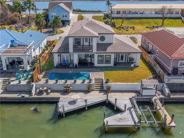 a aerial view of a house with swimming pool and furniture