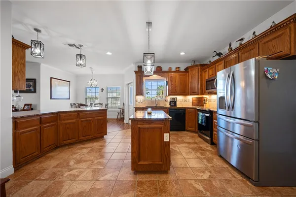 a kitchen with cabinets a sink and appliances