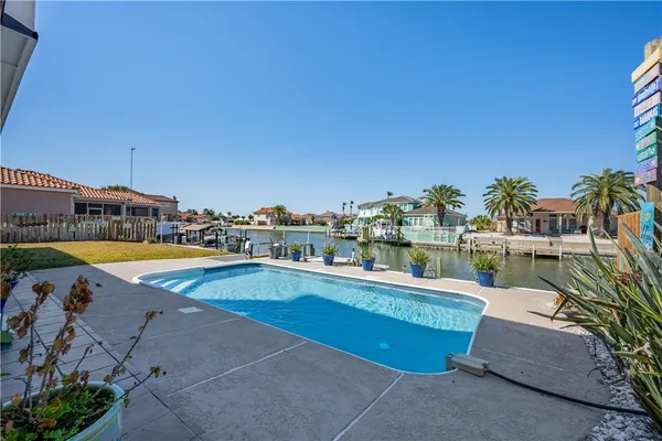 a view of a house with swimming pool and sitting area