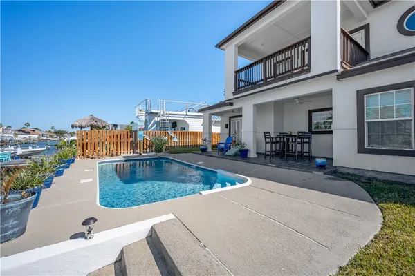 a view of a swimming pool with outdoor seating