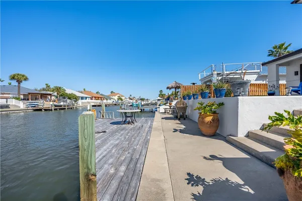 an aerial view of a swimming pool with outdoor seating