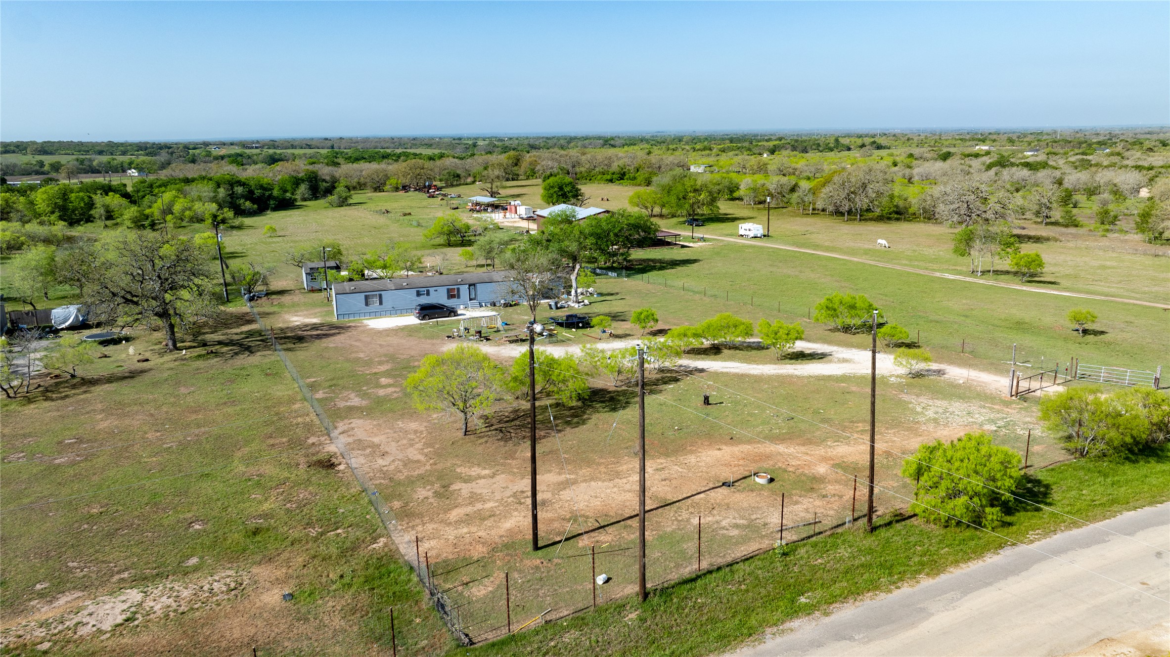 6575 Taylorsville Road Dale, TX 78616 - Photo 3 of 15 Vast green acreage provides a private, rural setting for this expansive property.