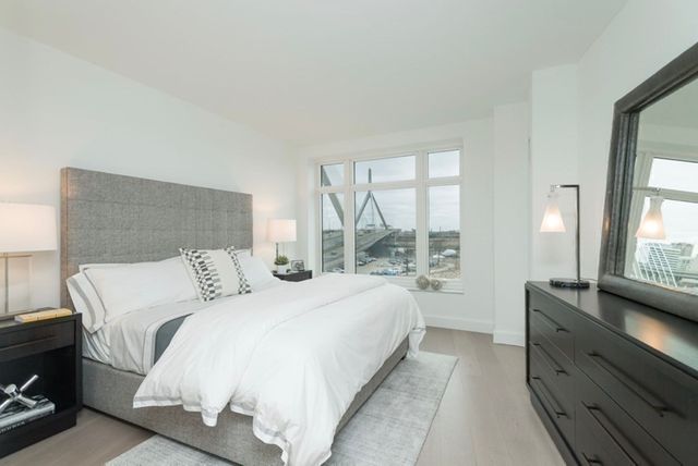 a dining room with furniture and a floor to ceiling window