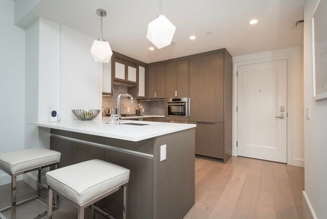 a kitchen with a sink cabinets and window