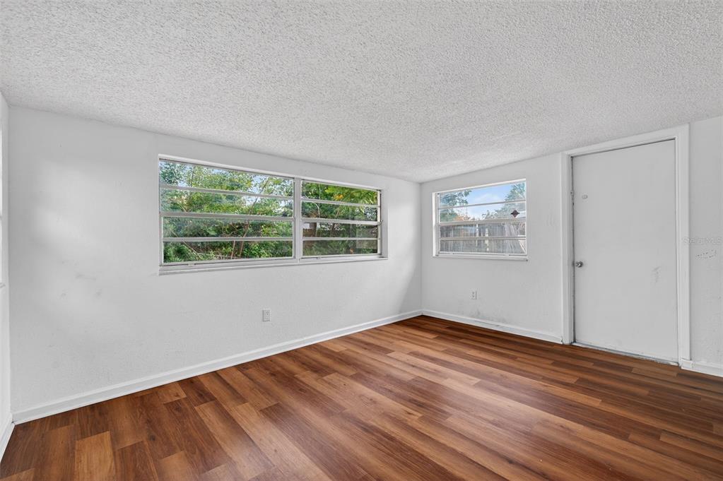 8626 Robilina Road Port Richey, FL 34668 - Photo 20 of 60 a view of empty room with wooden floor and fan