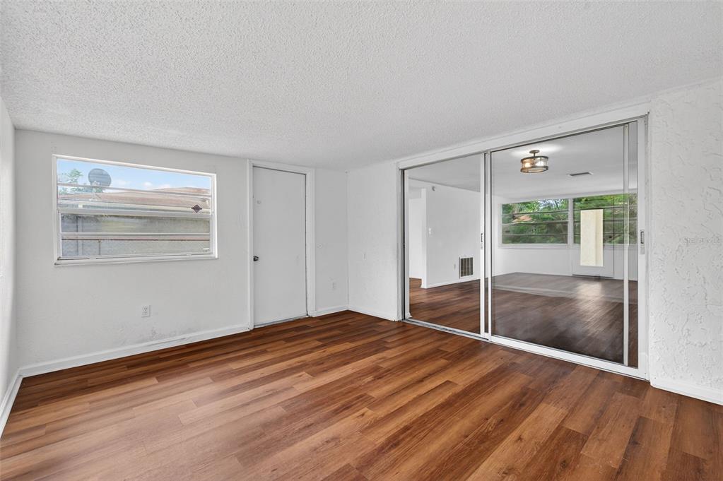 8626 Robilina Road Port Richey, FL 34668 - Photo 21 of 60 a view of empty room with wooden floor
