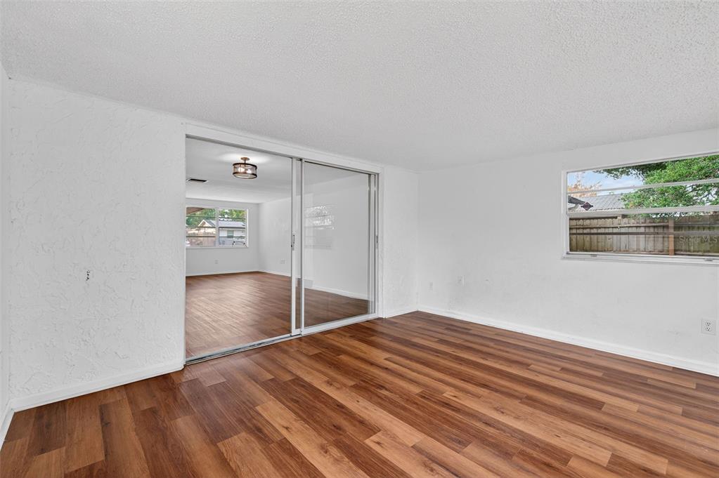 8626 Robilina Road Port Richey, FL 34668 - Photo 22 of 60 a view of empty room with wooden floor