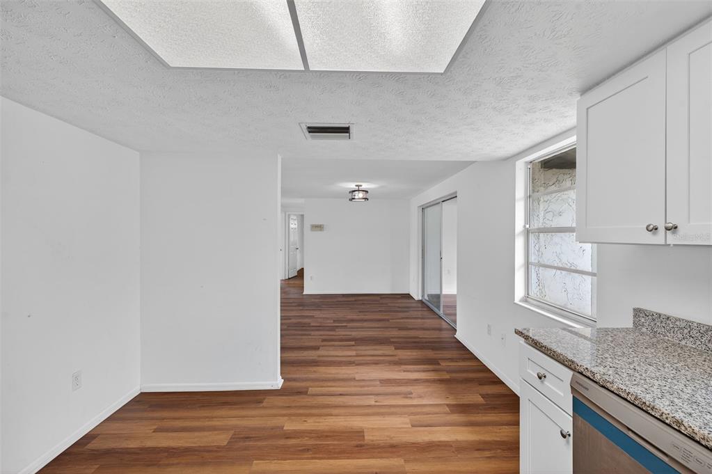 8626 Robilina Road Port Richey, FL 34668 - Photo 27 of 60 a view of a kitchen with wooden floor and staircase