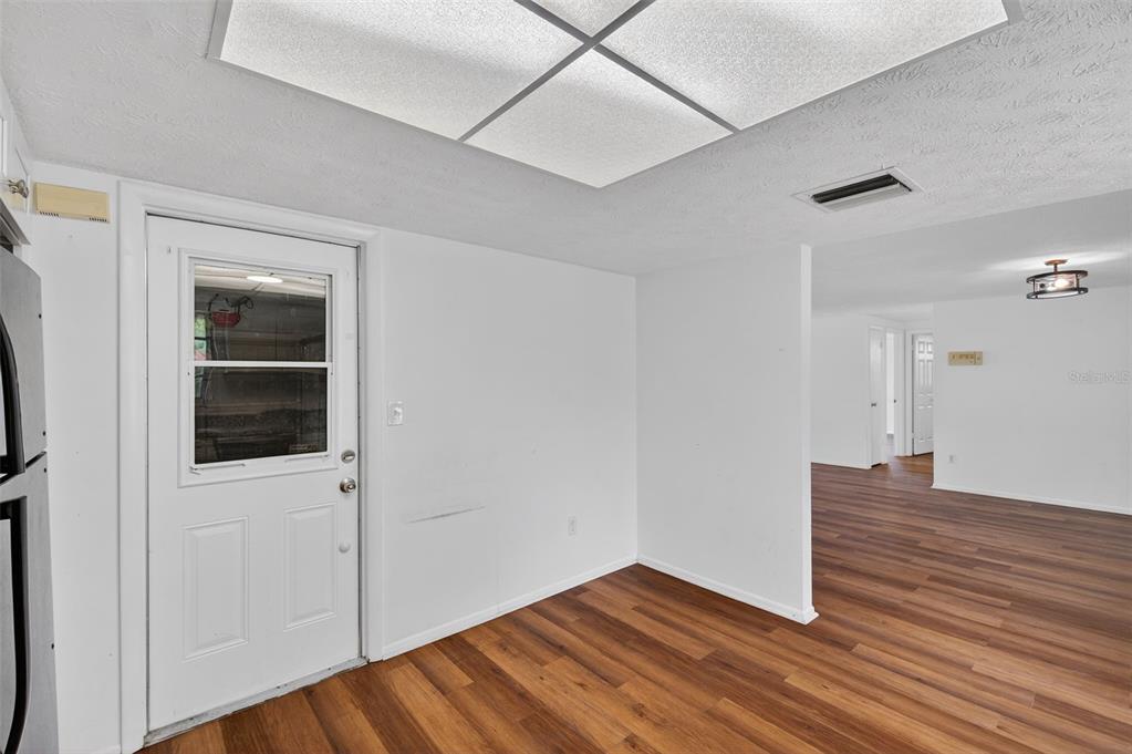 8626 Robilina Road Port Richey, FL 34668 - Photo 28 of 60 a view of an empty room with wooden floor and a window