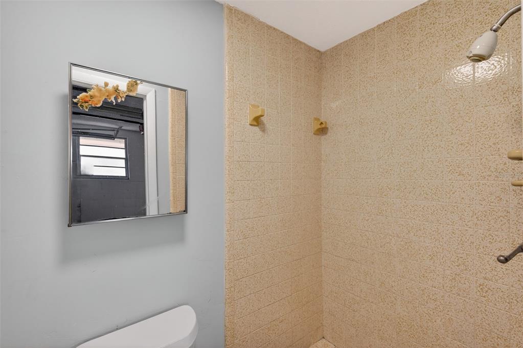 8626 Robilina Road Port Richey, FL 34668 - Photo 29 of 60 a bathroom with a toilet sink and mirror