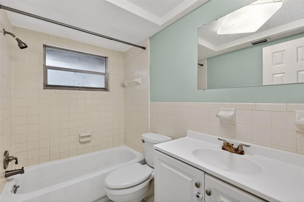 8626 Robilina Road Port Richey, FL 34668 - Photo 35 of 60 a bathroom with a sink a toilet and shower