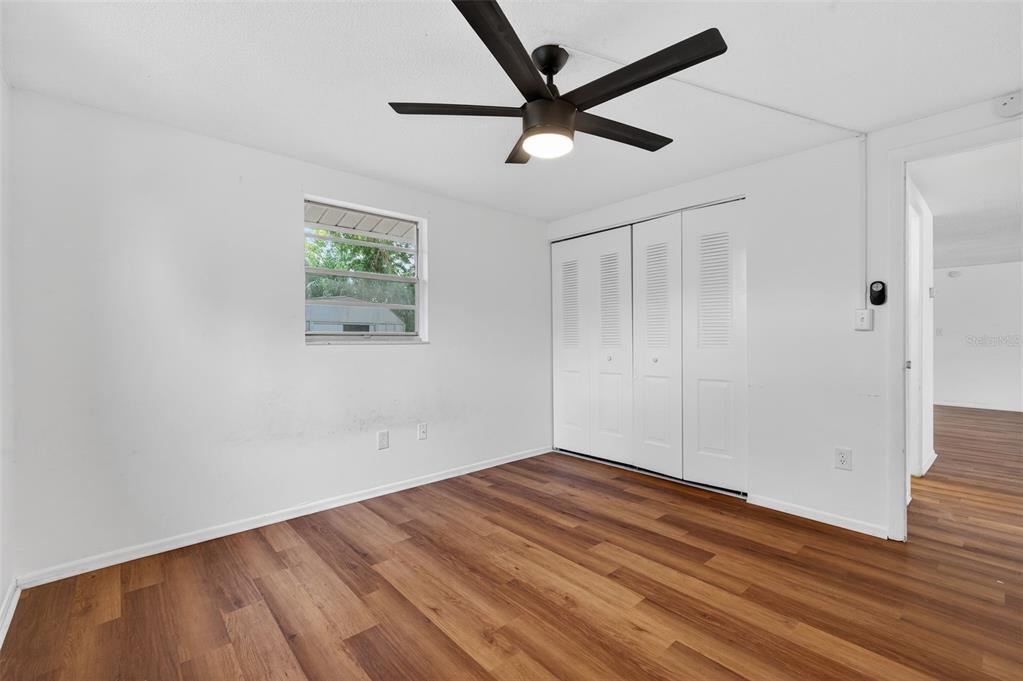 8626 Robilina Road Port Richey, FL 34668 - Photo 38 of 60 a view of empty room with wooden floor