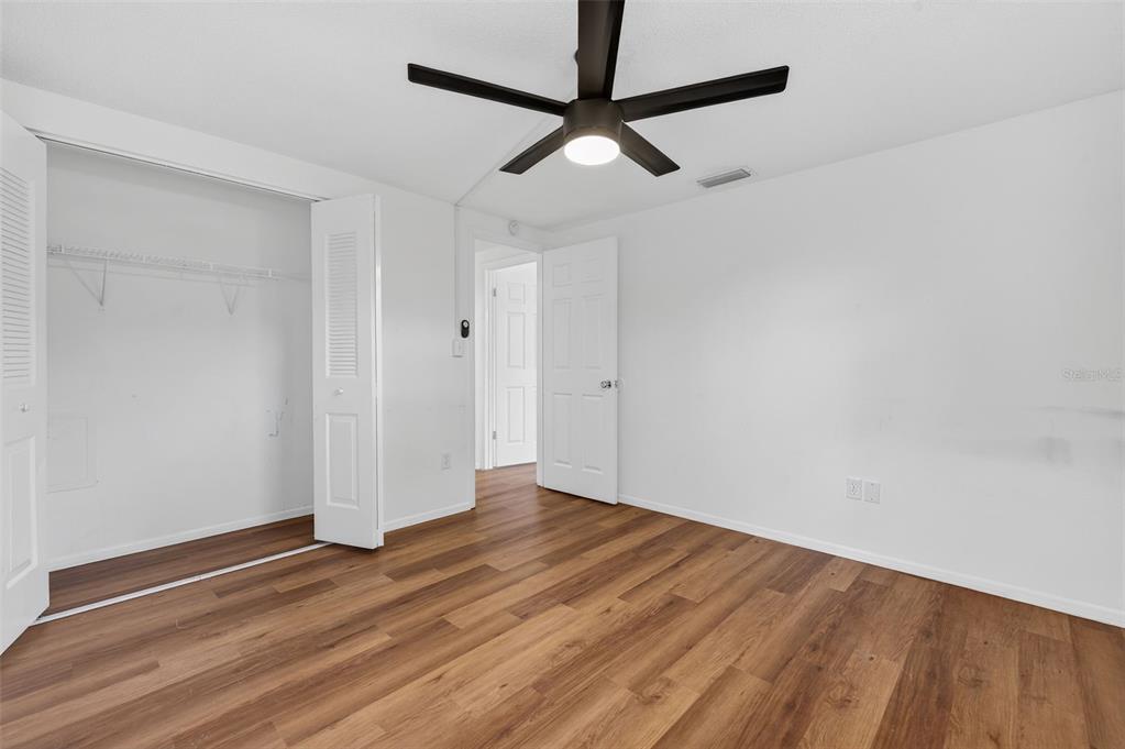 8626 Robilina Road Port Richey, FL 34668 - Photo 39 of 60 a view of empty room with wooden floor