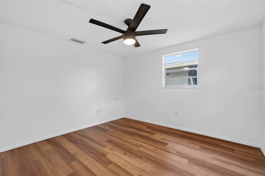 8626 Robilina Road Port Richey, FL 34668 - Photo 40 of 60 a view of empty room with wooden floor