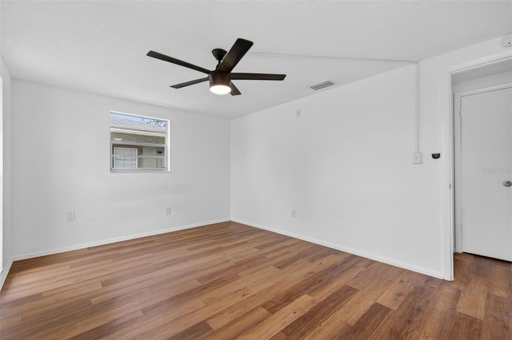 8626 Robilina Road Port Richey, FL 34668 - Photo 42 of 60 a view of a big room with wooden floor and windows in a room