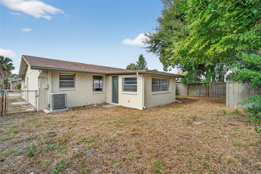 8626 Robilina Road Port Richey, FL 34668 - Photo 46 of 60 a view of a house with a yard and large tree