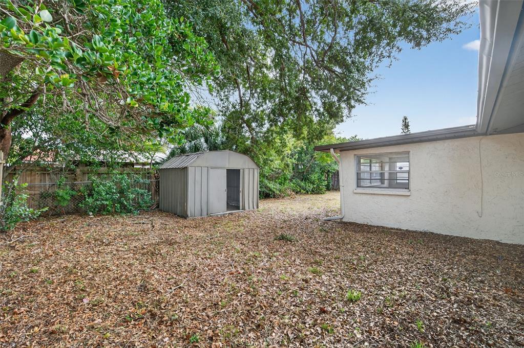 8626 Robilina Road Port Richey, FL 34668 - Photo 48 of 60 a front view of a house with a yard