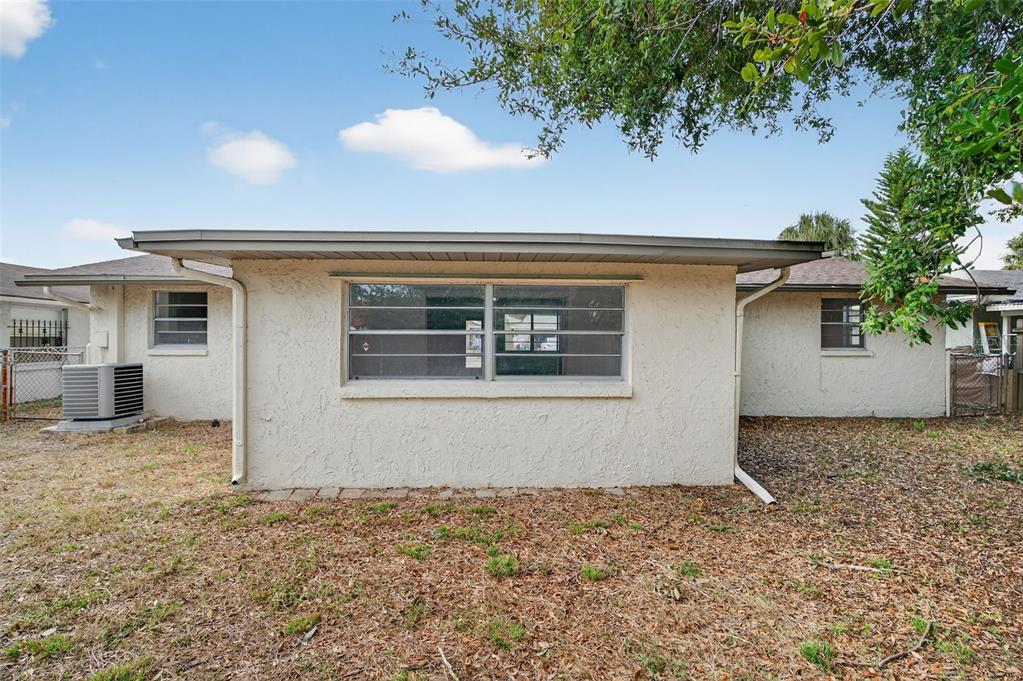 8626 Robilina Road Port Richey, FL 34668 - Photo 50 of 60 a view of a house with a backyard