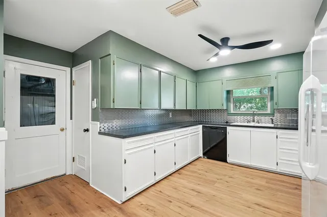 a kitchen with granite countertop a sink and cabinets