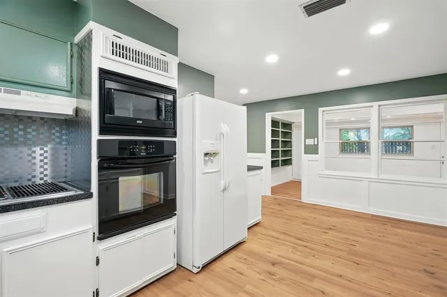 a kitchen with stainless steel appliances a stove and a refrigerator