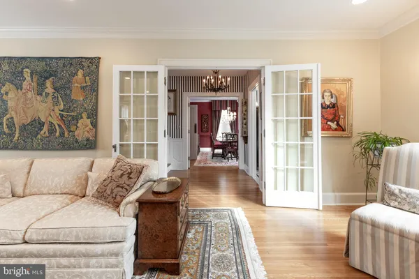 a bathroom with two painting on the wall and a window