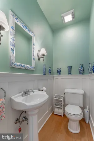 a view of entryway with wooden floor and front door