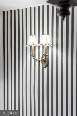 a spacious bedroom with a large bed and a chandelier