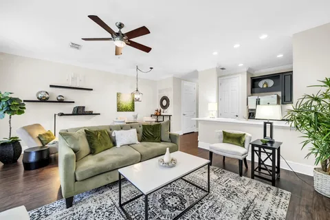 a living room with furniture kitchen view and a table