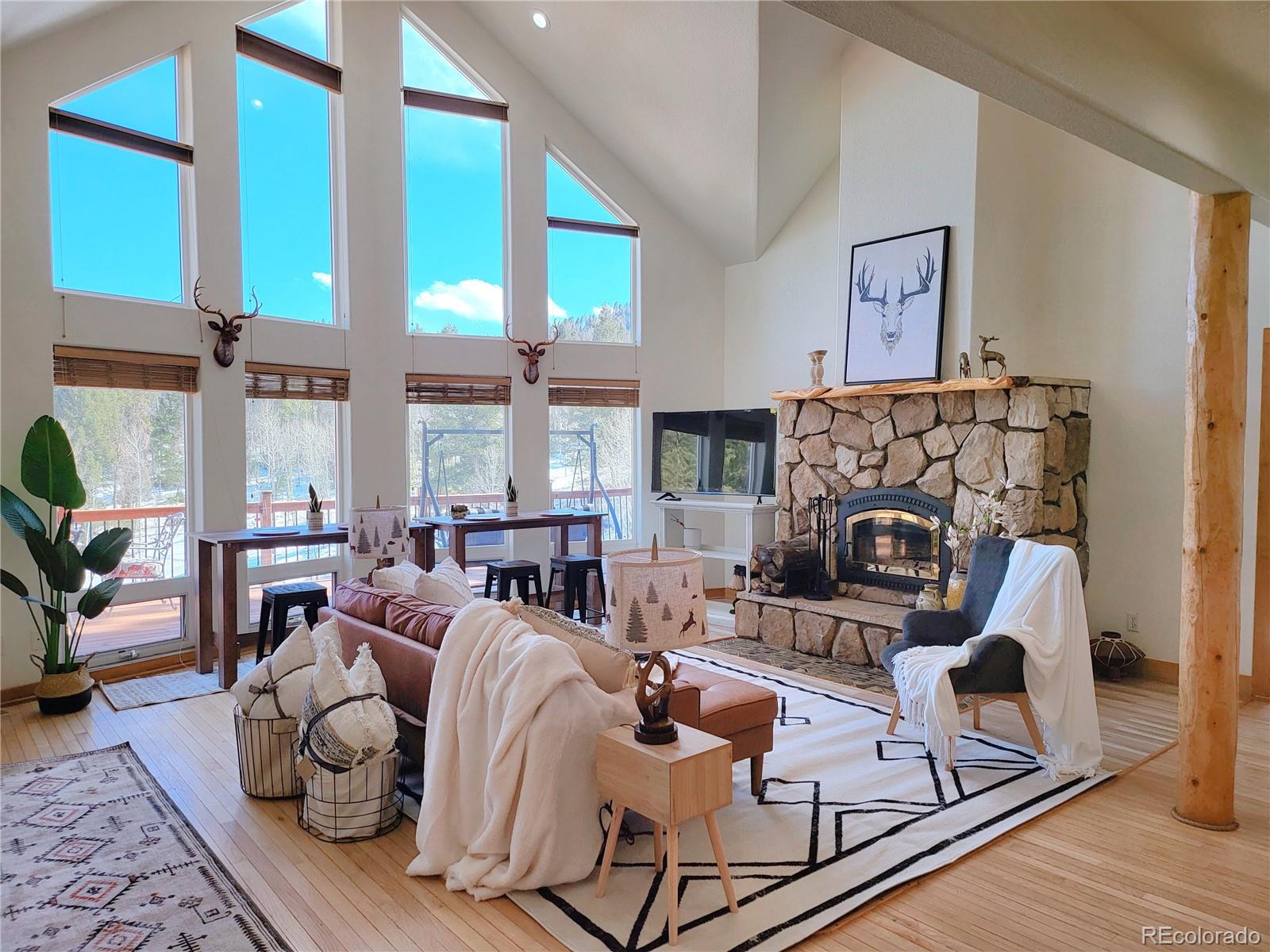 20133 Silver Ranch Road Conifer, CO 80433 - Photo 1 of 40 a living room with furniture fireplace and a large window