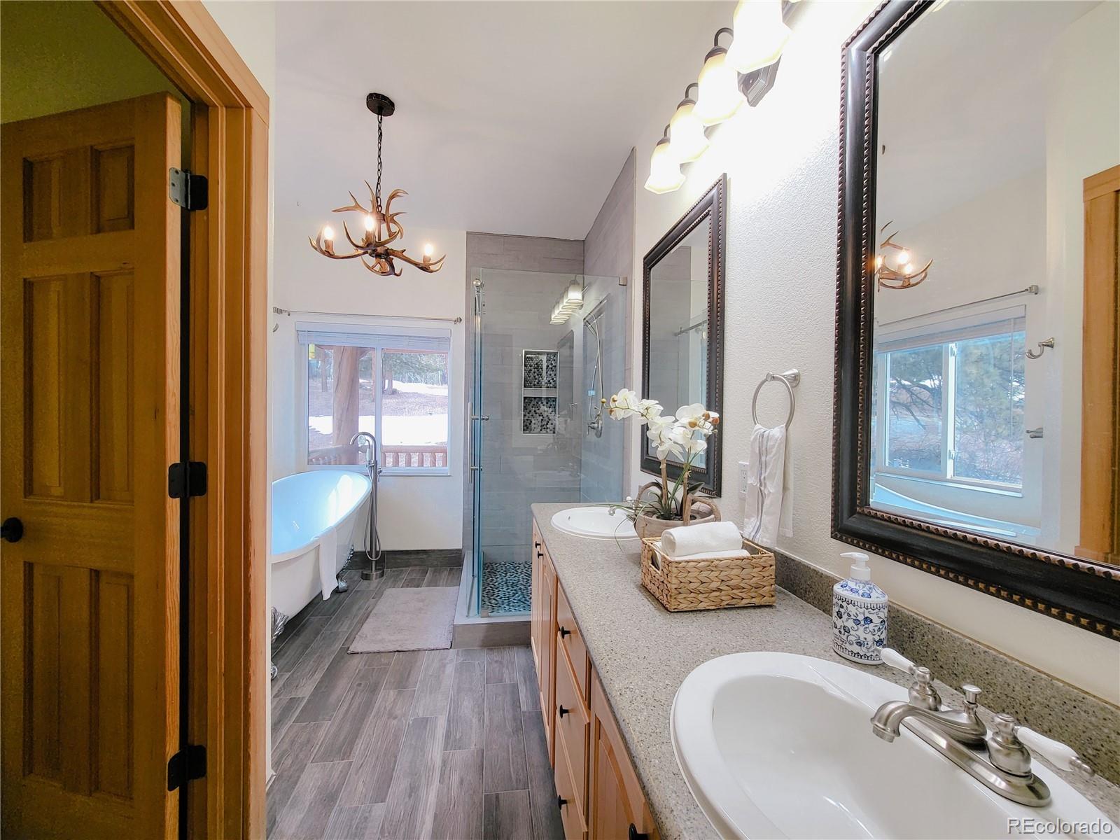 20133 Silver Ranch Road Conifer, CO 80433 - Photo 17 of 40 a bathroom with a double vanity sink mirror and shower