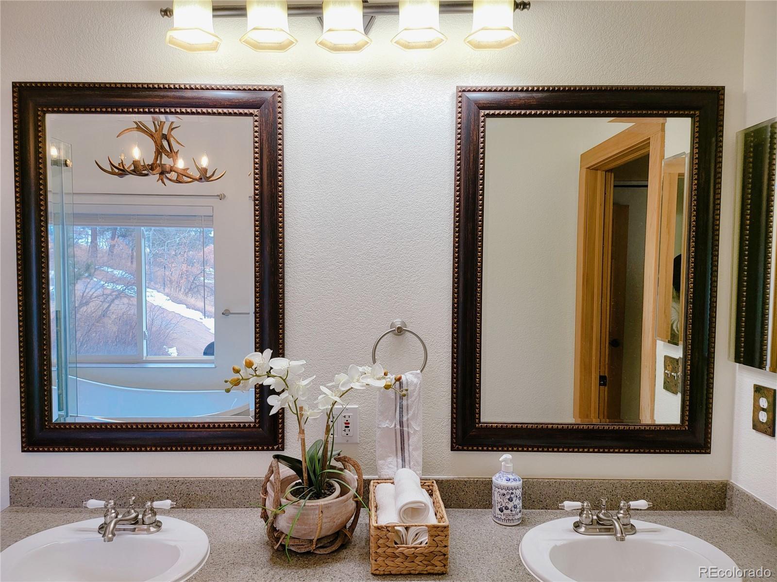 20133 Silver Ranch Road Conifer, CO 80433 - Photo 18 of 40 a bathroom with a sink and a mirror